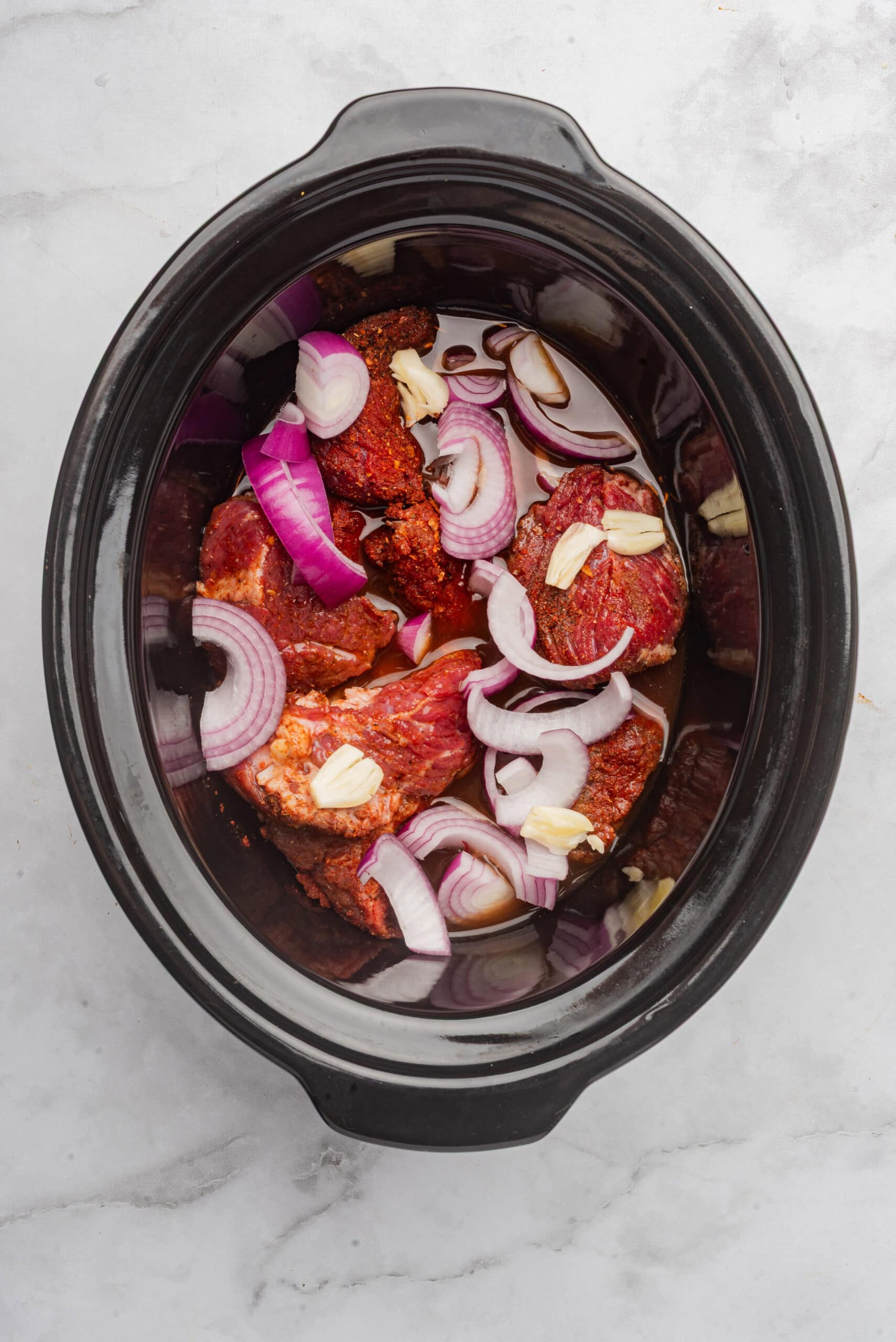 Crockpot BBQ pulled beef with onions and garlic