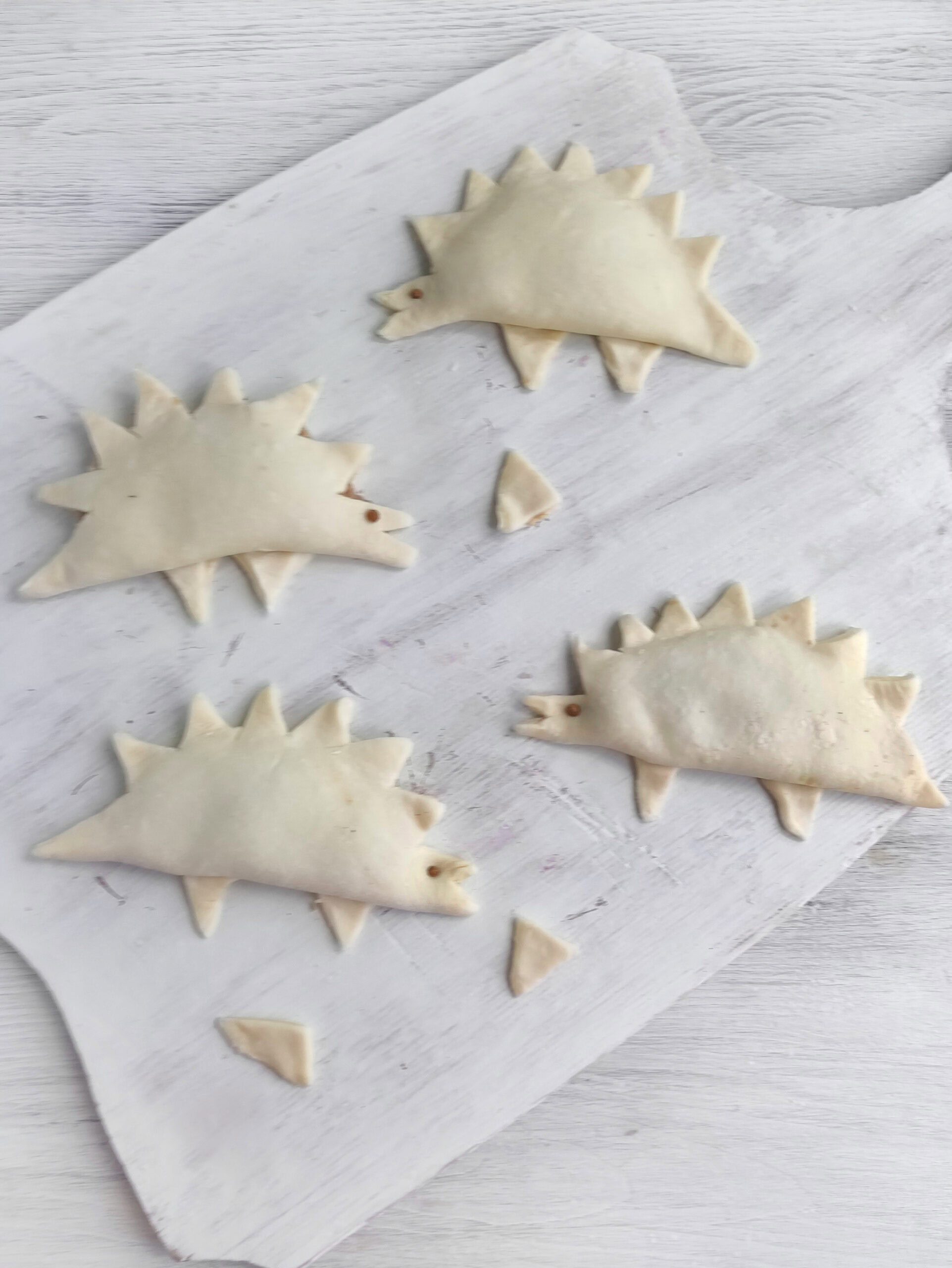 Dinosaur chicken empanadas before baking
