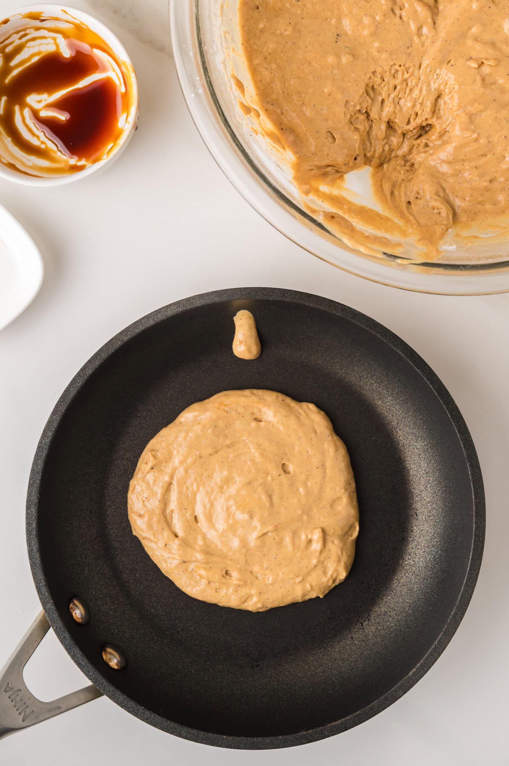 Gingerbread pancake cooking in skillet
