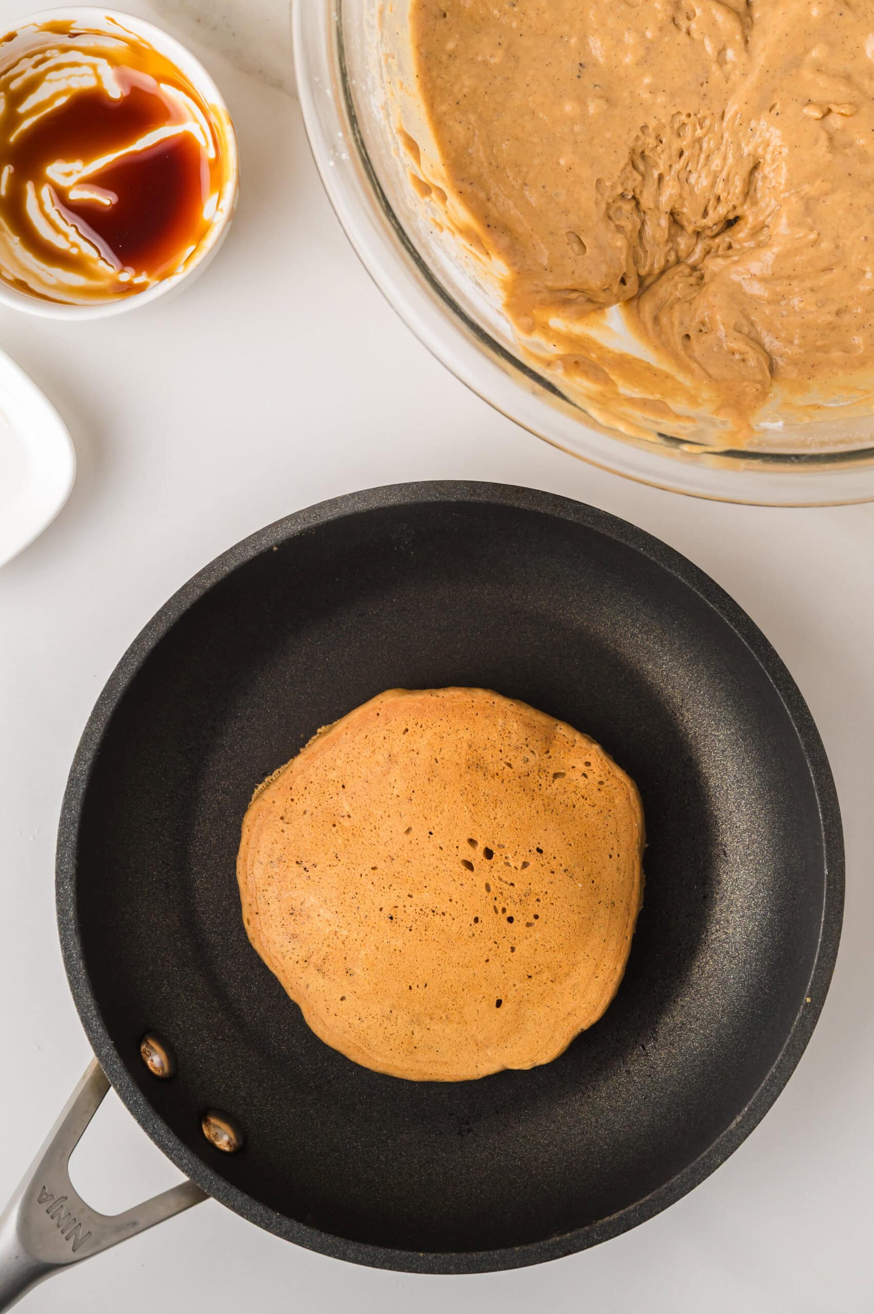 Gingerbread pancake browning in pan