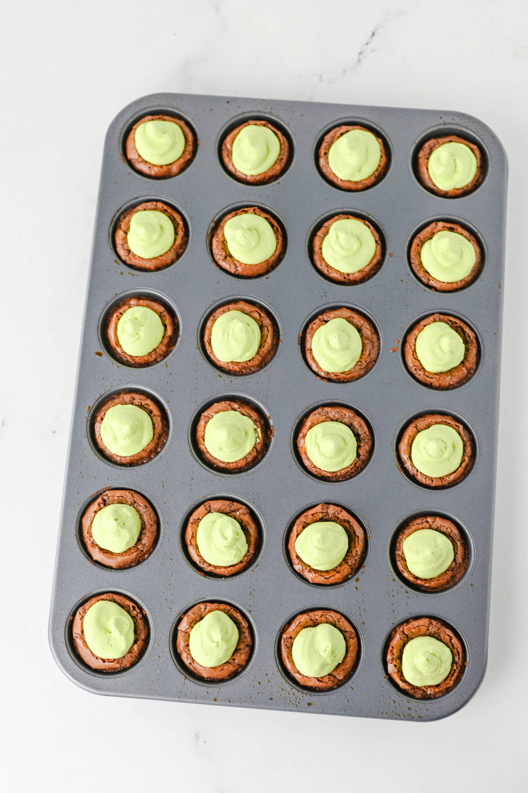 Grinch brownie bites with green frosting
