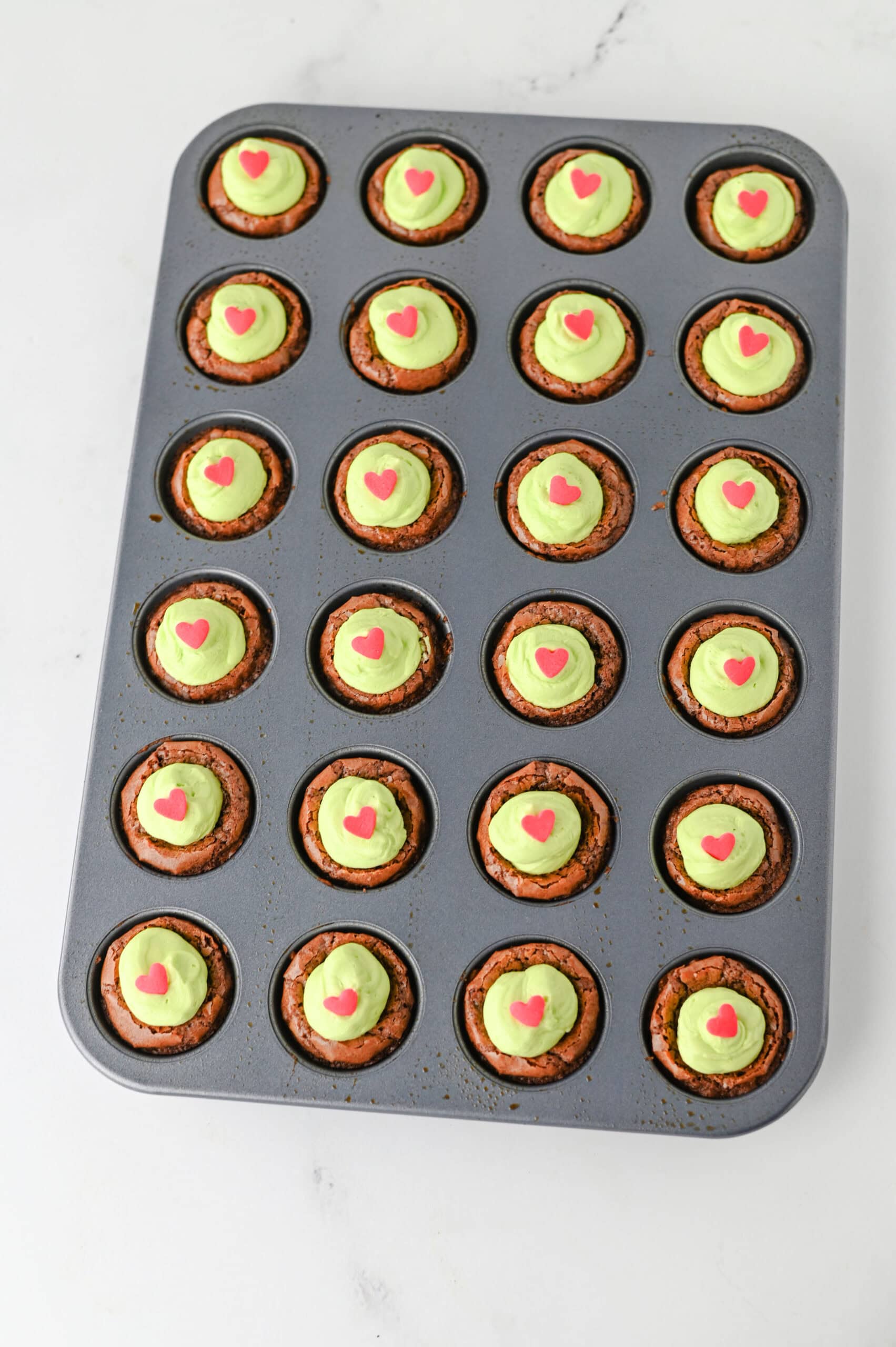 Grinch brownie bites with heart sprinkles