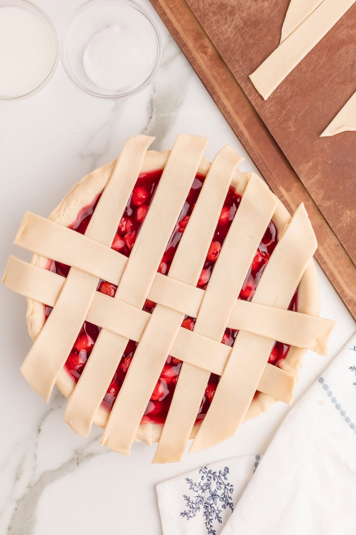 place a new strip across the center of the pie and fold down the strips to partially cover it