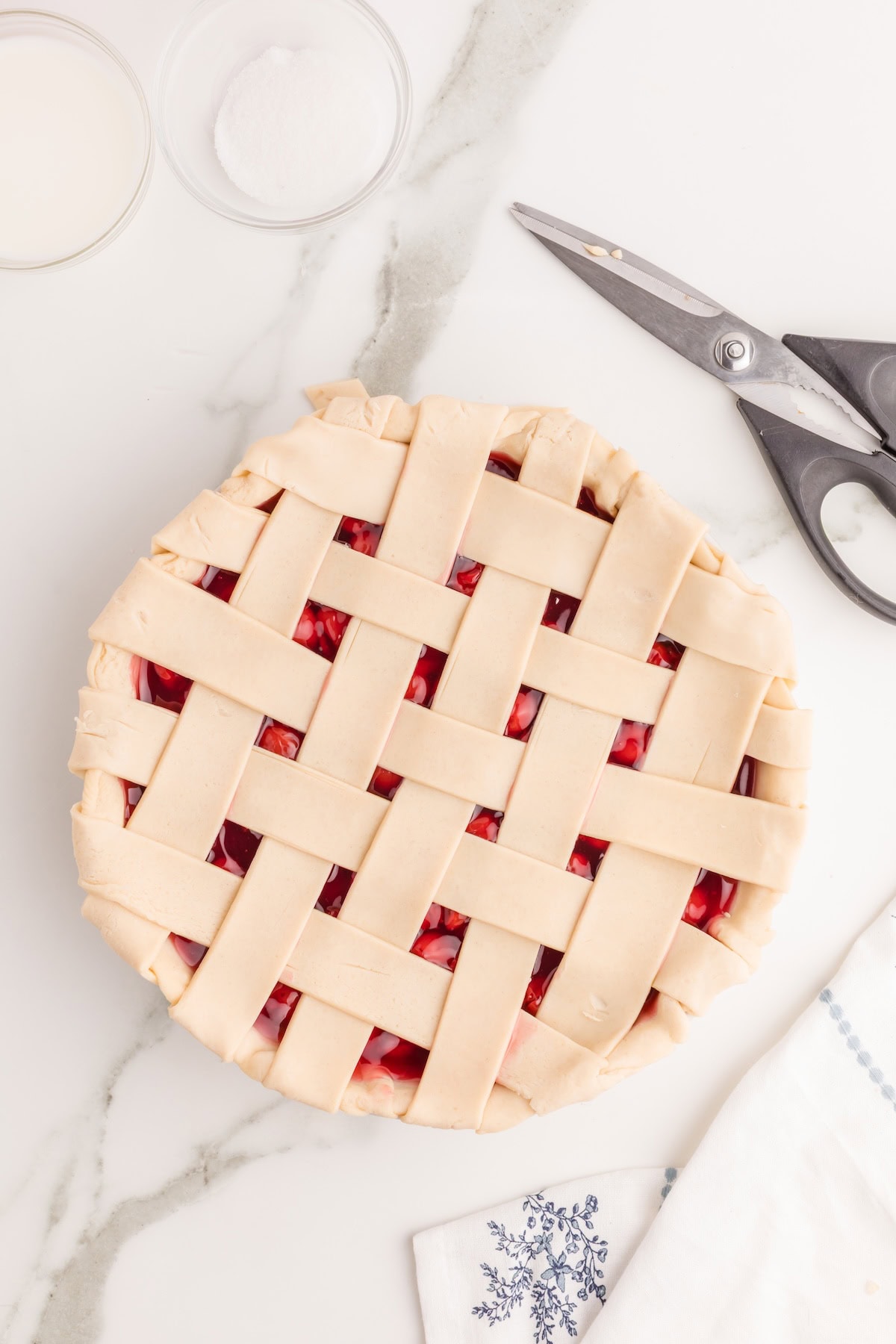cut off the excess pie crust from around the edges, leaving just enough hangover to pinch with the bottom crust