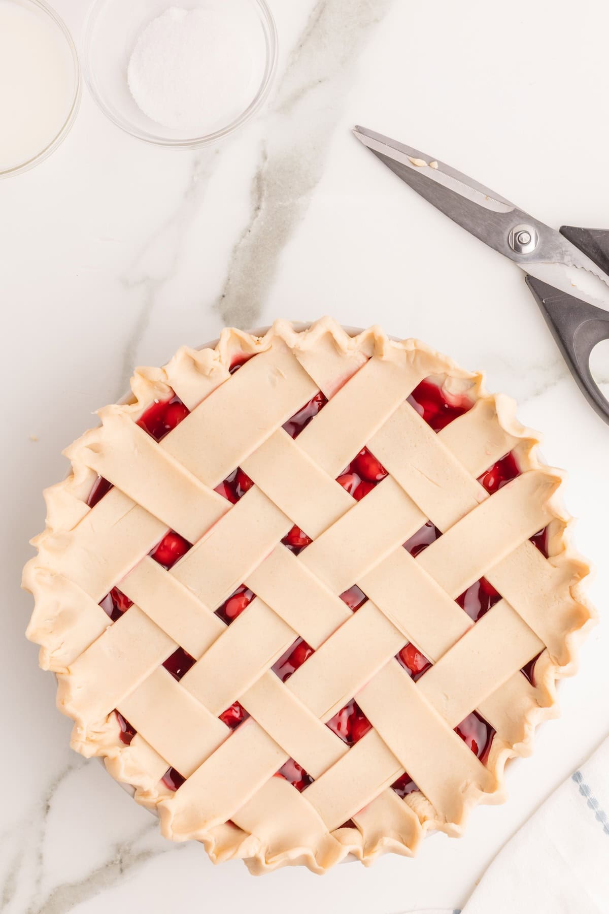 use your finger and thumb to pinch the bottom and top crusts together all the way around and make a slightly fluted pattern as shown