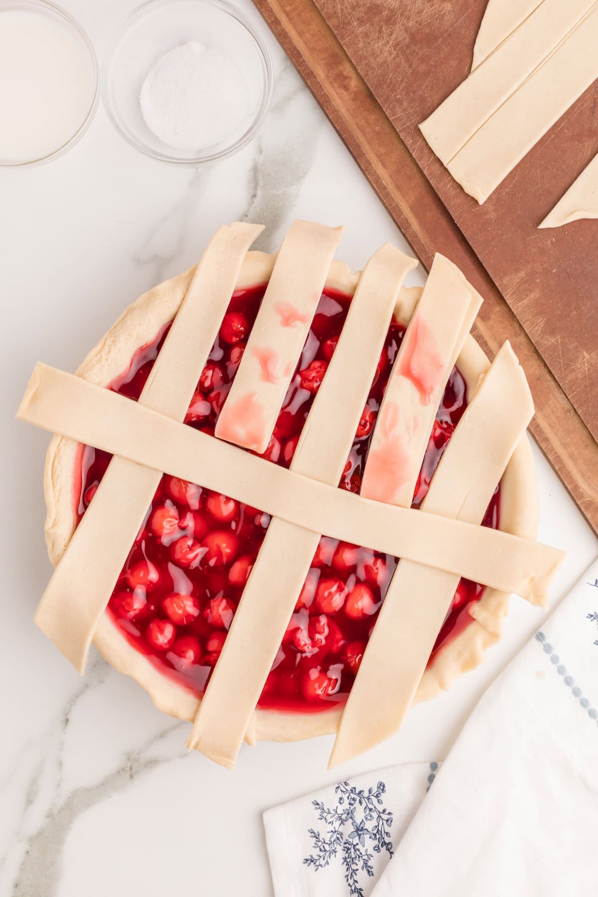 lay one of the longest strips across the center of the pie