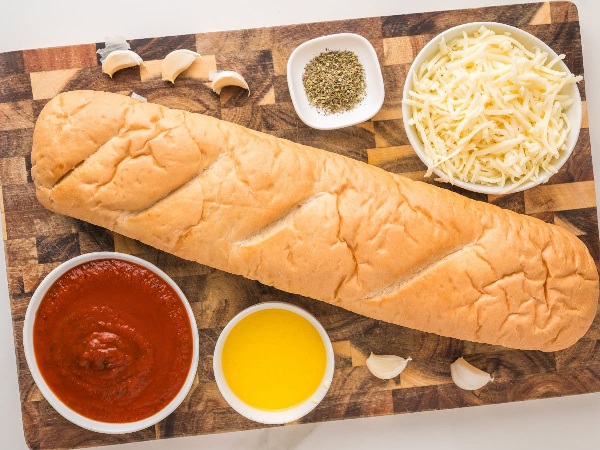 French bread pizza ingredients with garlic butter and mozzarella