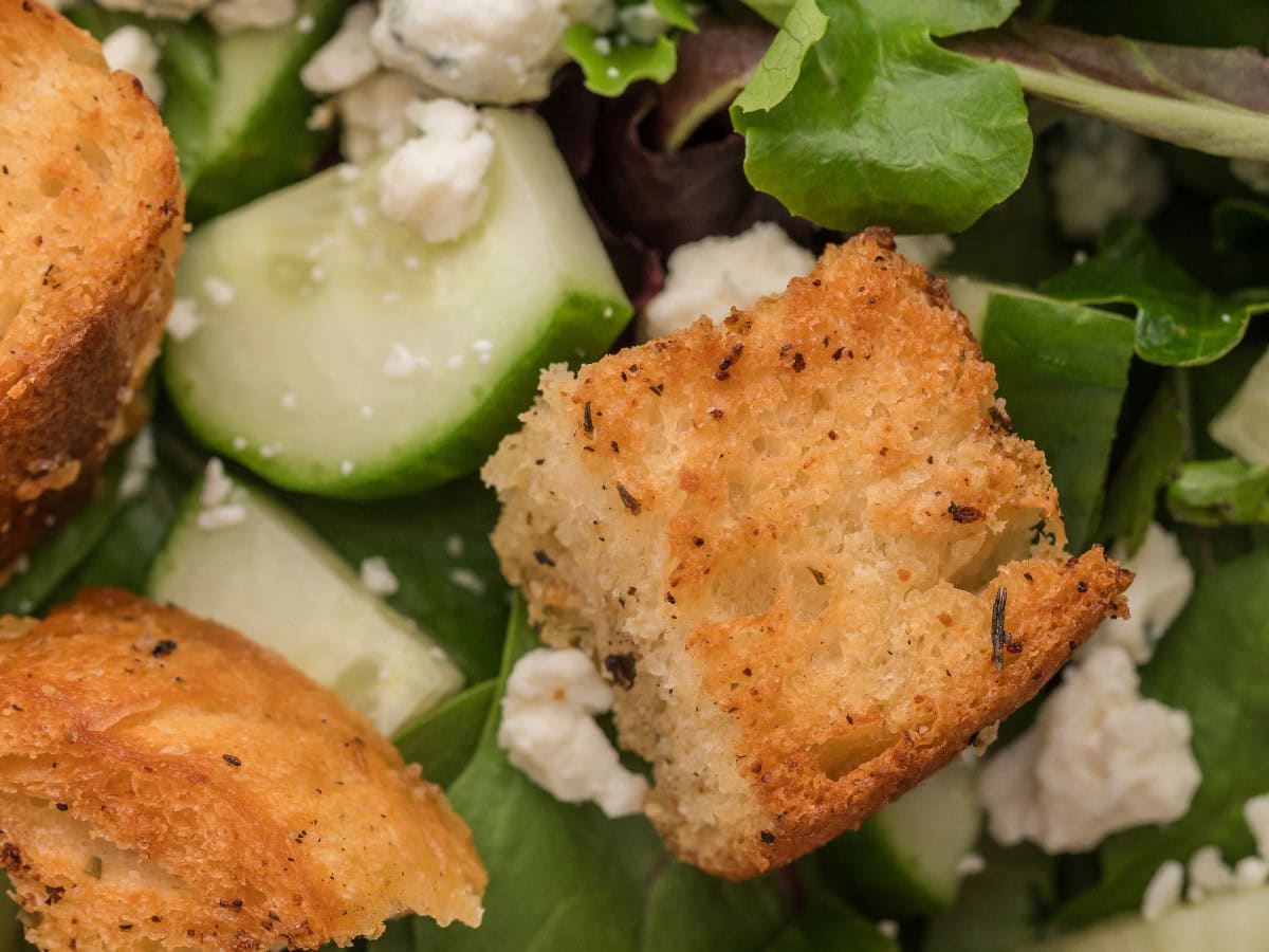 Garlic herb butter croutons on fresh greens