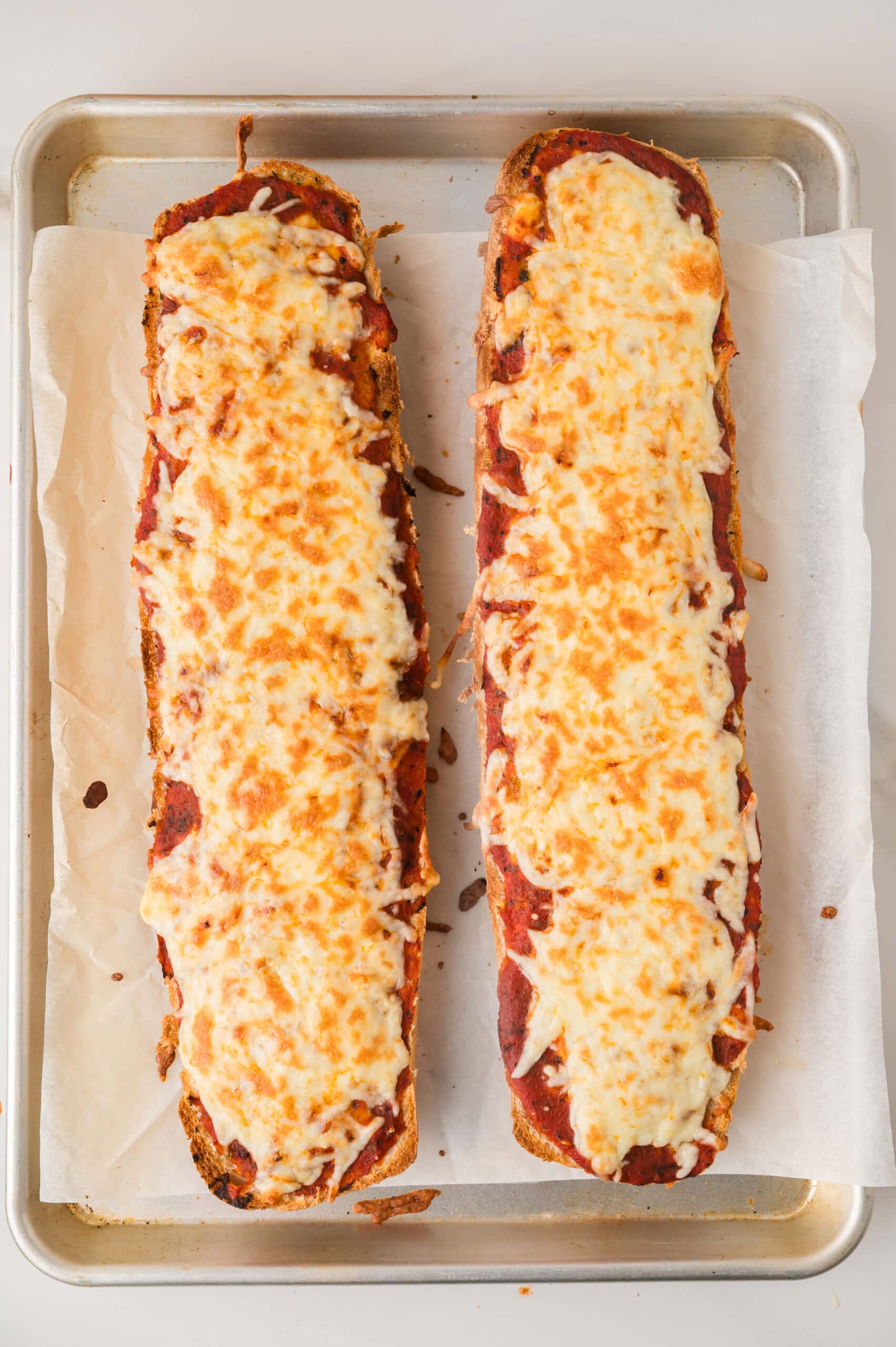 Oven baked French bread pizza with golden cheese