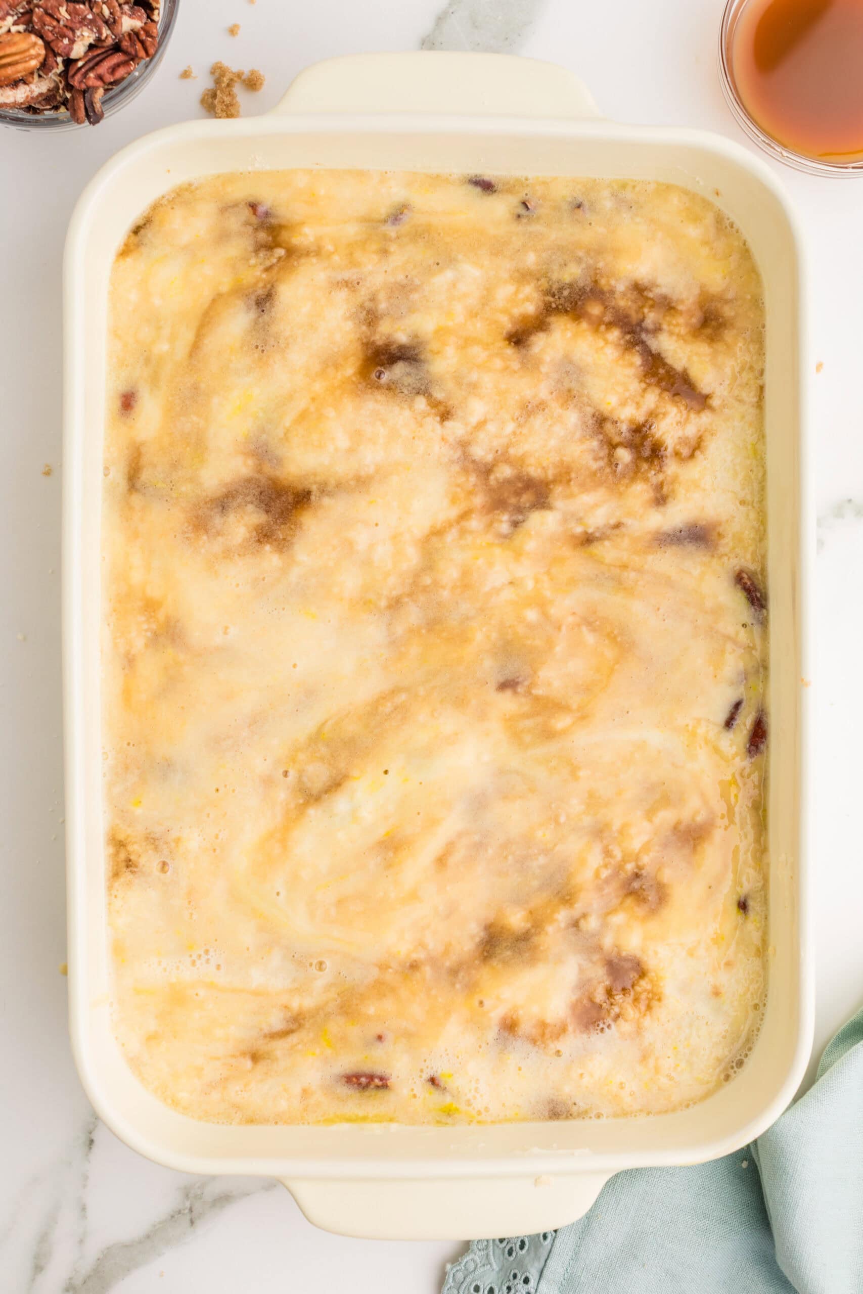 Unbaked pecan pie dump cake with creamy topping