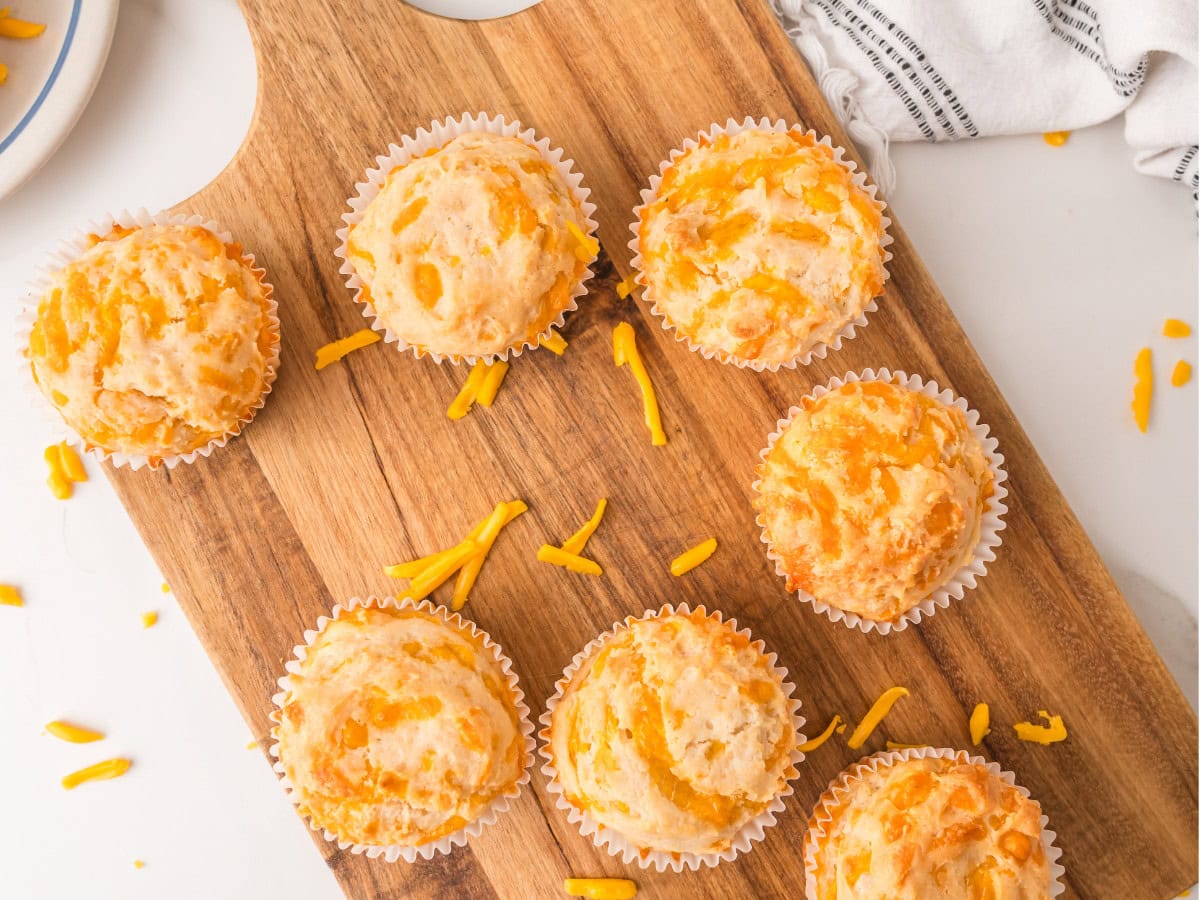 Golden homemade muffins with shredded cheddar cheese